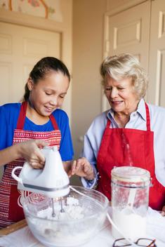 Girl (10-12) baking with grandmother