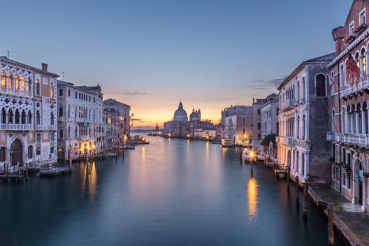 A long-exposure view of Venice at sunrise from the Accademia Bridge, overlooking the Grand Canal. This photo is part of a series of travel photos from Venice, Italy in beautiful and diverse light conditions.