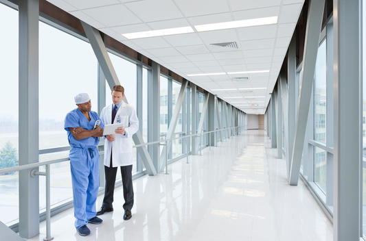 nurse and doctor walking down hallway