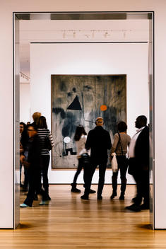 Museum goers look at a painting at the Museum of Modern Art (MoMA).