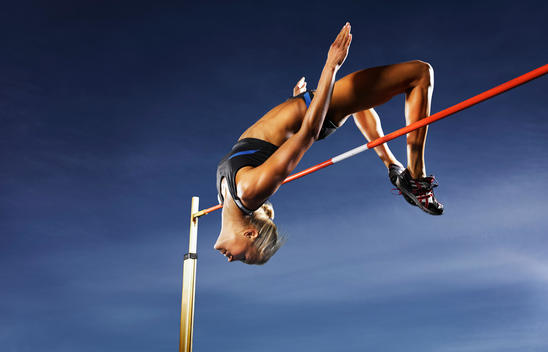 Athletic woman mid high jump