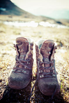 Pair of dirty hiking boots on land