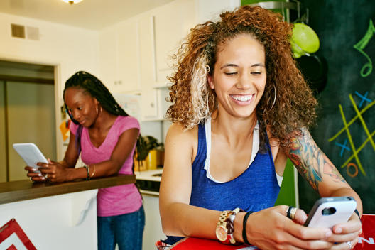 Women using technology in kitchen