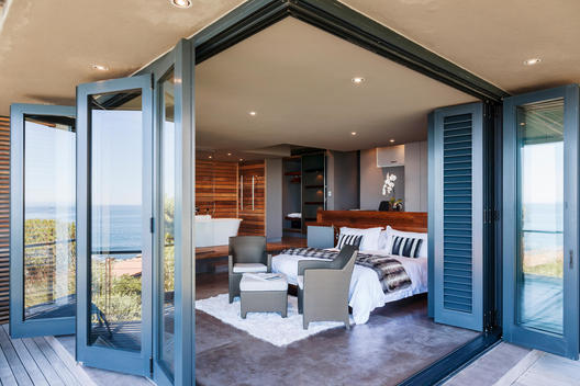 Doors on patio open to modern bedroom