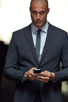Nigel Barker in suit with phone