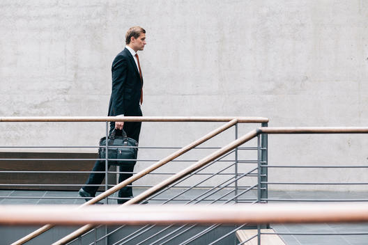 Portrait of young business consultant going to work with his bag