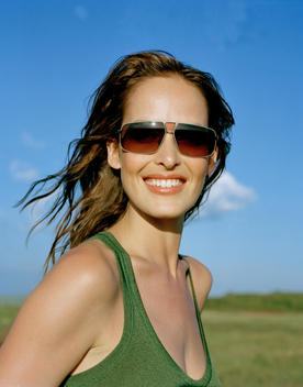 Young Woman In Green Top With Sunglasses