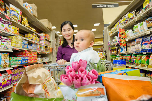 Asian mother shopping in grocery store with daughter