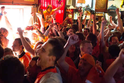 Dutch football fans wearing orange celebrate when watching Holland compete in World Cup 2014 tournament at a pub in Maastricht, The Netherlands