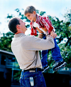 Dad Lifting Son Up In Air
