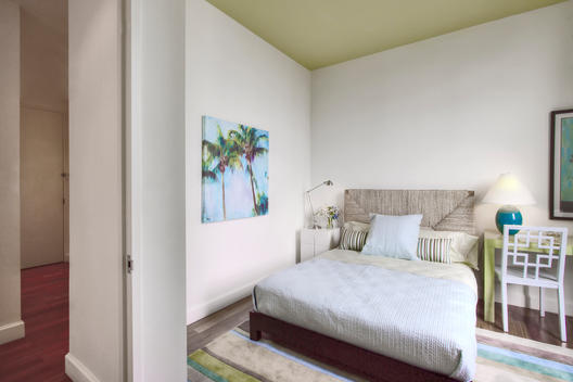 Tropical-Themed Spare Bedroom With Hallway Visible