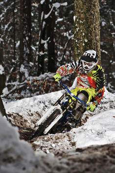 Mountain biker riding forest track in winter