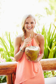 Caucasian woman drinking from coconut