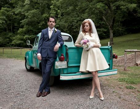 Newly-weds beside vintage car