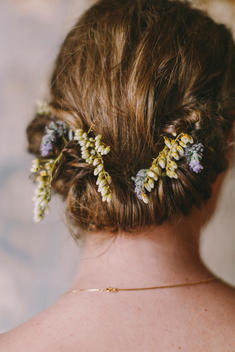 Back of Woman's Head with Hair Twisted Updo and Flowers