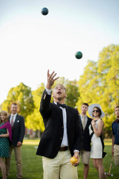 Caucasian man juggling croquet balls