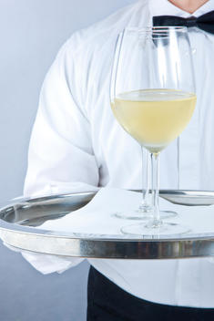 Waiter Holding Tray with Glasses of White Wine