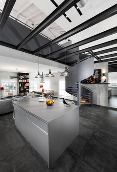 Modern cool penthouse. Open plan kitchen and living room with modern features and spiral staircase