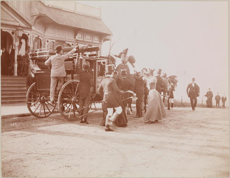 A Coach With Four Horses Stationed By The Curb In Front Of A Building With An Open Porch.