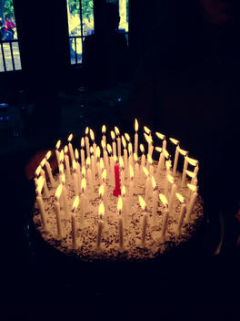 Birthday cake with 60 candles burning