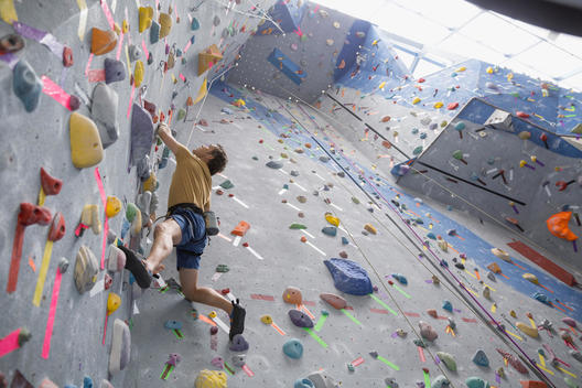 Man climbing indoor rock wall