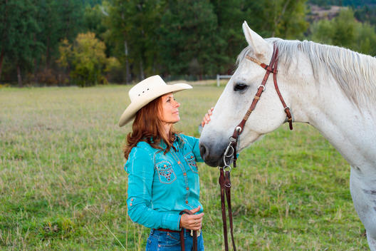 Portrait of Montana cowgirl with quarter horse.