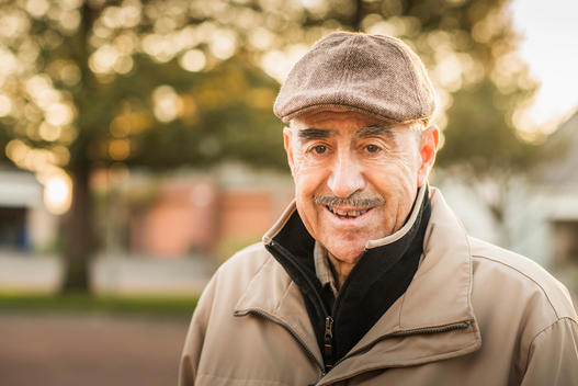Older Hispanic man smiling outdoors