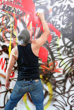 Man tagging wall with graffiti