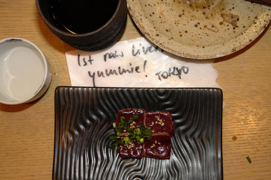 Various plates in Tokyo restaurant with note: \