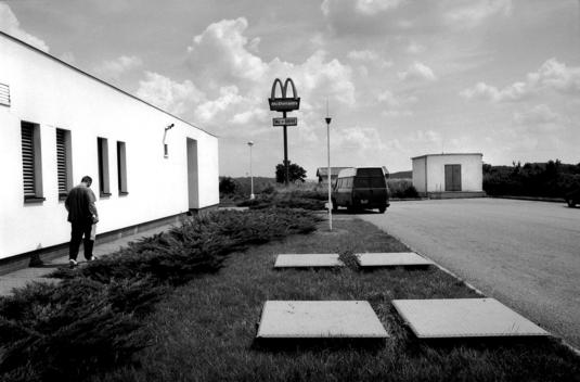 Mzizovice, Czech Republic July 1997 Behind a highway gas station a McDonald\'s sign rises above the landscape. This American fast food Restaurant chain has become a symbol of the transition in much of Eastern Europe.