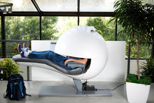 A man lays in a sleep pod at Google