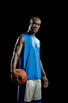 Studio portrait of basketball player with ball