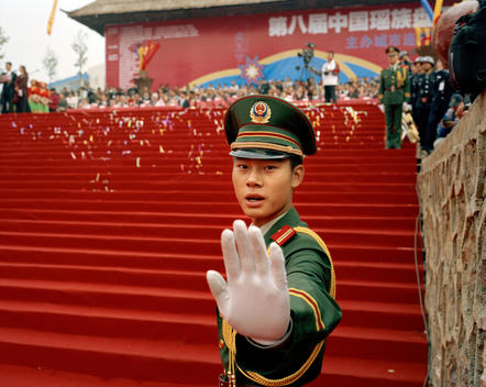 A Chinese Army Officer Holds Out His Hand Gesturing For The Photograph Not To Be Taken During A Public Ceremony In The Chinese City Of Lianzhou