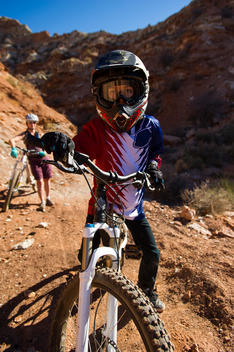 Young boy mountain biking in the desert.