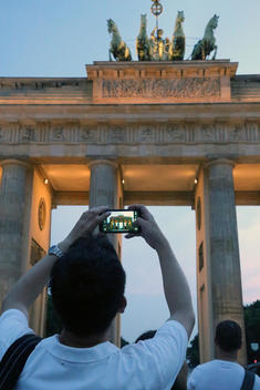 Taking a picture of the Brandenburg Gate at night, Berlin