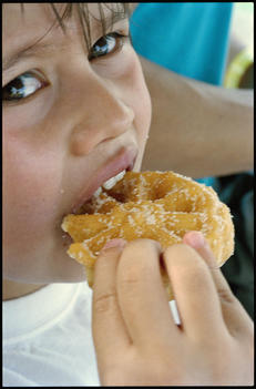 Young Boy Eating Pastry