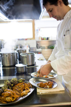 Griggle Stube Restaurant chef Thorsten Probost preparing seafood in kitchen