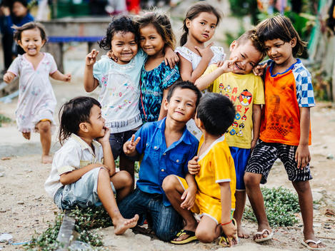 Students and local children pose along the abandoned railroad tracks next to Empowering Youth in Cambodia\'s Lakeside School in an impoverished neighborhood of Phnom Penh, Cambodia.