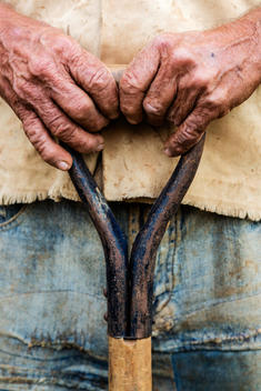 Close up of older man\'s hands holding shovel
