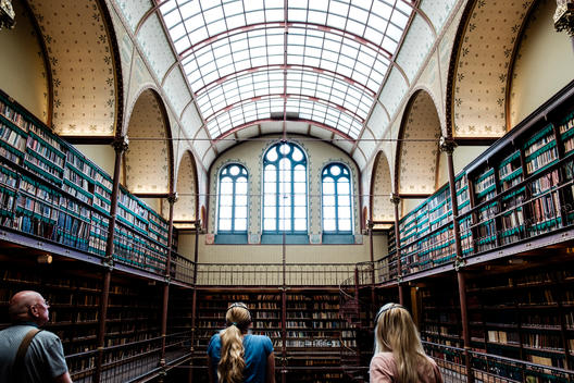 Tourists look at the Rijksmuseum Research Library in Amsterdam.