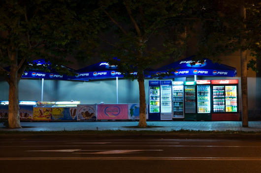 Vacant Vending Machines And Vendor\'S Booths Along Street At Nighttime.
