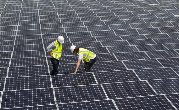 Technicians working on solar panels