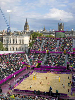 Players from the Women?s GB team (foreground) play Canada (far side) in the Preliminary Phase of Beach Volleyball. Competing in Britain's first women's Olympic beach volleyball competition since the Atlanta games in 1996, Zara Dampney and Shauna Mullin ca