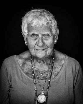 Black and white portrait of elderly woman short white hair slight smile
