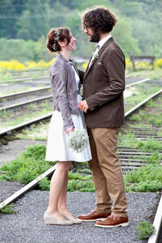 Happy bridal couple standing between rails