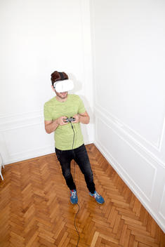 Young Man Gaming with virtual Reality headse