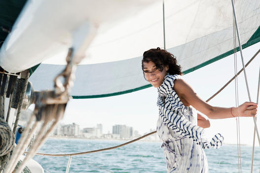 Young woman on yacht wearing striped scarf