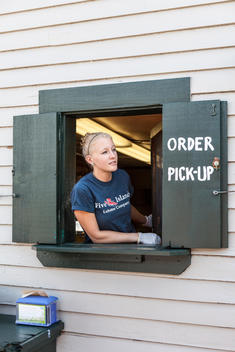 A Five Islands Lobster Co. employee serves orders from the pick-up window in Georgetown, Maine.
