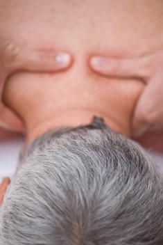 Man receiving a back and neck massage