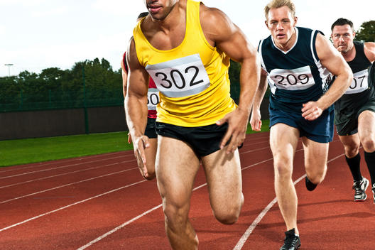 Athletes Running On Sports Track